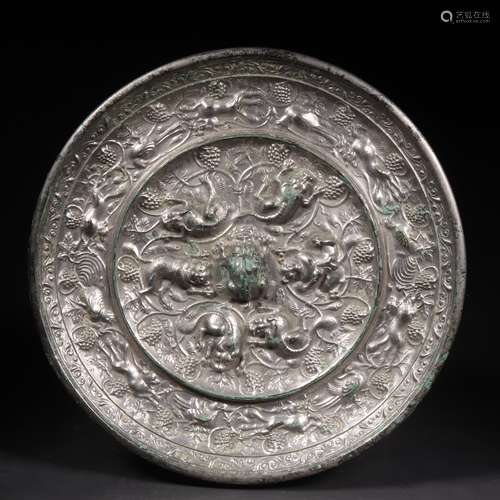 A BRONZE MIRROR WITH BEAST AND GRAPE 