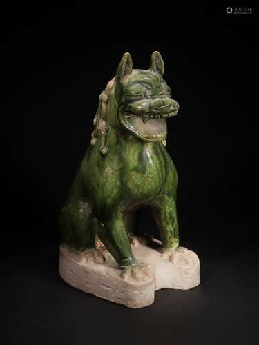 A GREEN GLAZED FIGURE A LION 