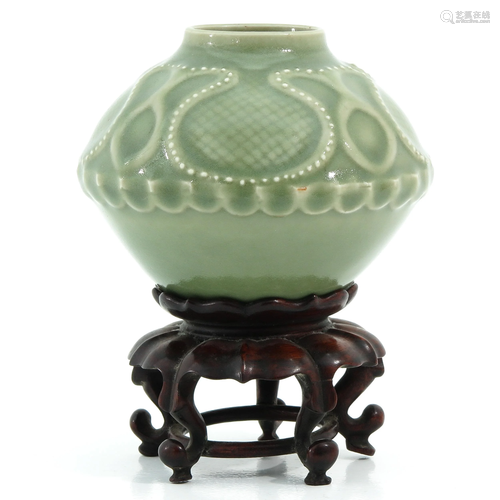 A Celadon Vase on Carved Wood Stand