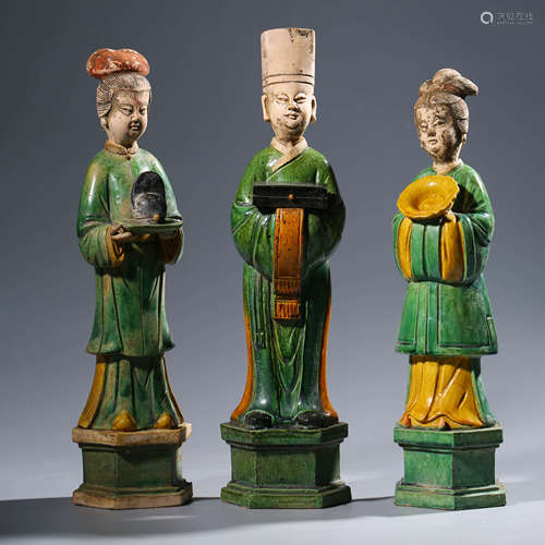 A Set Of Three Polychrome-Enamelled Pottery Attendants