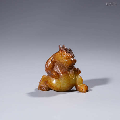 A Carved Russet Jade Auspicious Beast Ornament