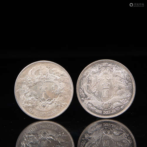 A PAIR OF CHINESE QING DYNASTY SILVER DOLLARS