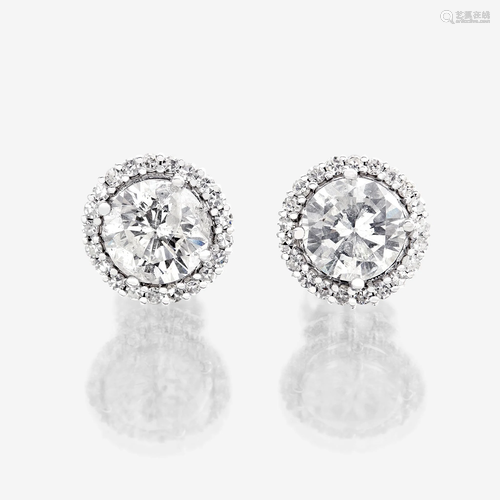 A pair of diamond and eighteen karat white gold