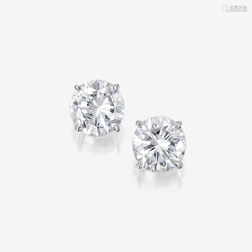 A pair of diamond and eighteen karat white gold stud