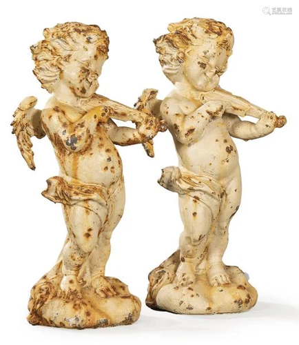 Couple of angels playing the violin in cast iron,