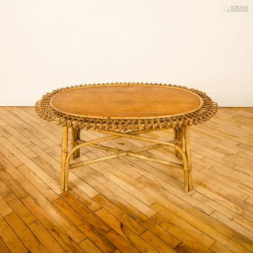 A FRENCH OVAL RATTAN TABLE WITH OAK TOP