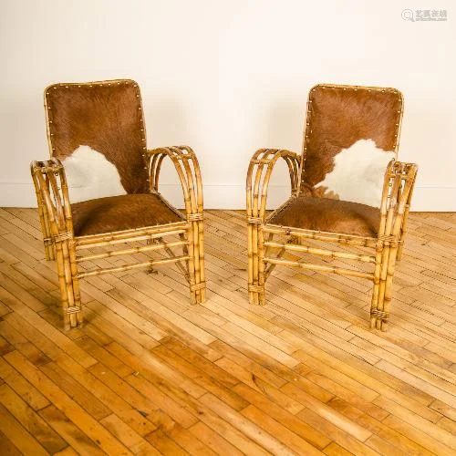 PAIR MCM RATTAN ARM CHAIRS WITH COWHIDE UPHOLSTERY