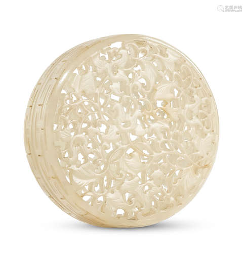 A SMALL PALE GREEN JADE CIRCULAR RETICULATED TWO-PART 'FLOWE...