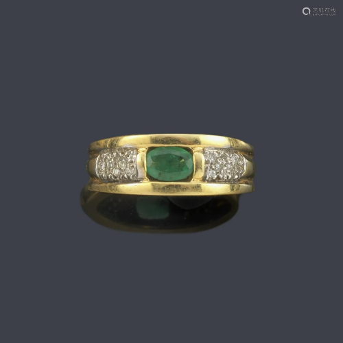 Ring with central emerald and band of diamonds in 18K