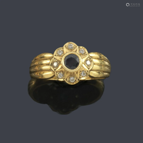 Ring with central rosette with sapphire and border of