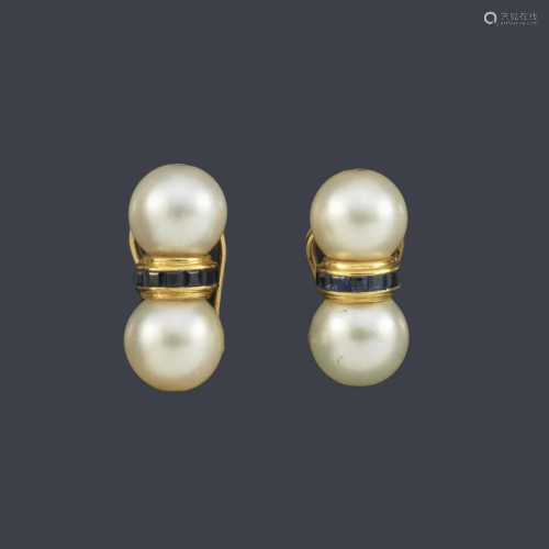 Double pearl earrings with a center calibrated sapphire