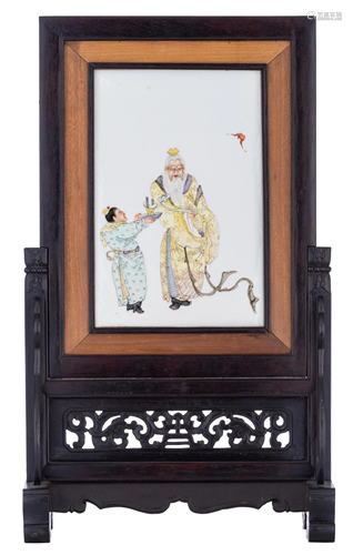 A Chinese famille rose porcelain plaque within a carved