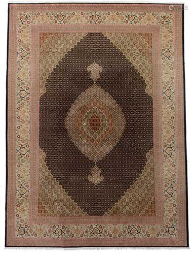 An Oriental Tabriz rug, decorated with a teardrop