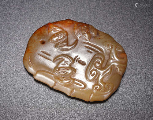 A Carved Creamy White Jade Pendant