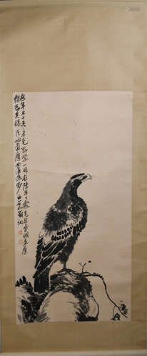 A CHINESE PAINTING OF EAGLE STANDING ON A ROCK