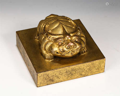 A GILT BRONZE BEAST SEAL