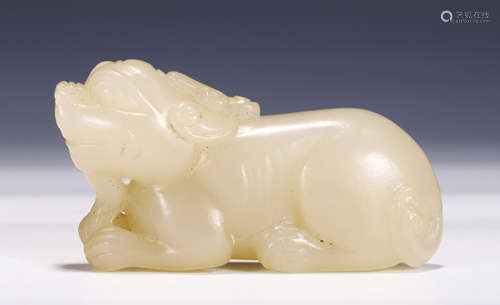 A CARVED WHITE JADE BEAST CARVING