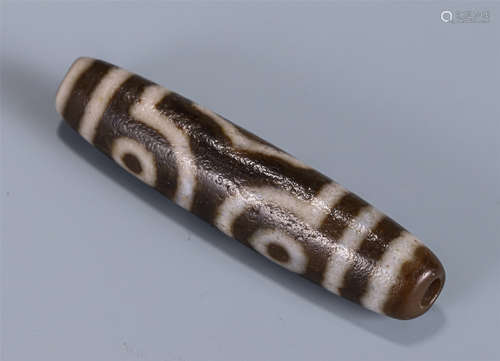 A TIBETAN THREE-EYED DZI BEAD