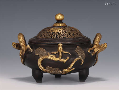 A CHINESE BRONZE PARCEL GILT TRIPOD CENSER