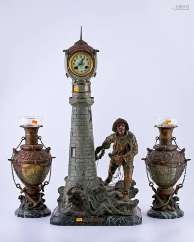 Spelter clock representing a lighthouse at sea.