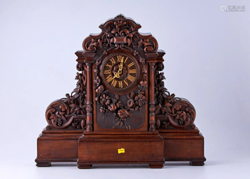 Hand carved walnut clock with floral motifs