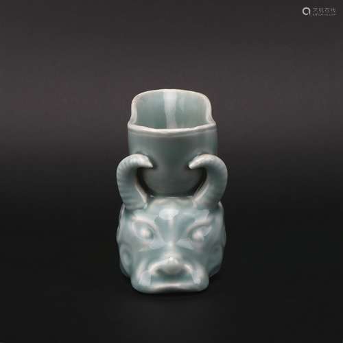 A celadon-glazed cup