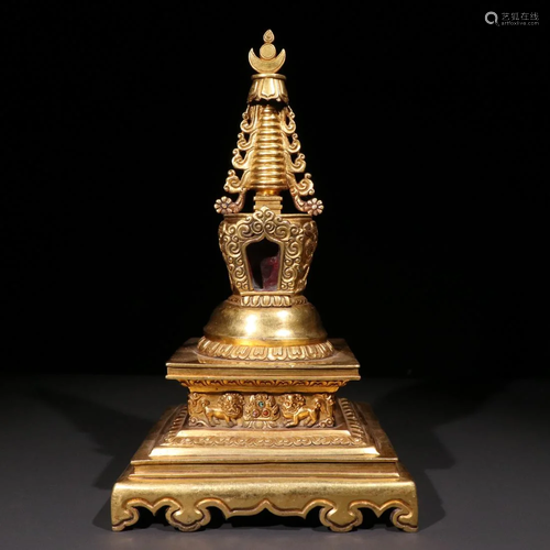 A GILT BRONZE OF A STUPA