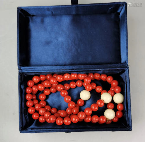 A Chinese red coral nacklace with four elephant bone