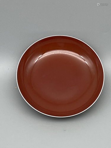 A monochrome red-glazed deep plate, H 16 cm