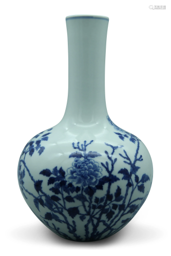 A blue and white bottle vase, decorated with flower