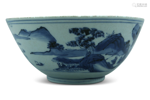 A blue and white bowl, decorated with a mountainous