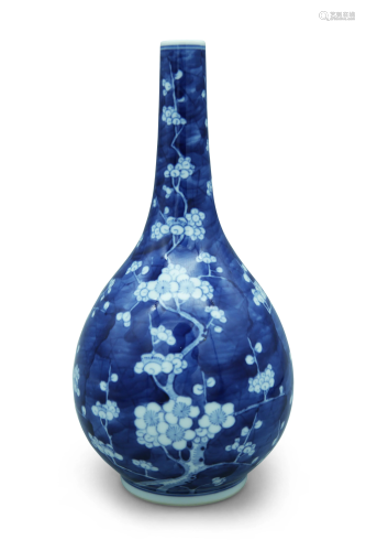 A blue and white bottle vase, decorated with prunus