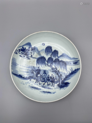 A blue and white plate, decorated with figures