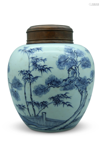 A blue and white ginger jar, decorated with pine,