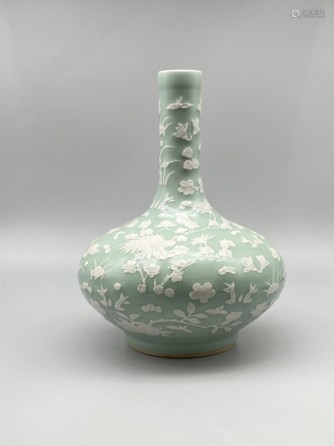 A celadon bottle vase, with slip decoration