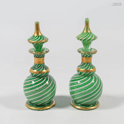 A pair of decanters in glass, with mostly green, white