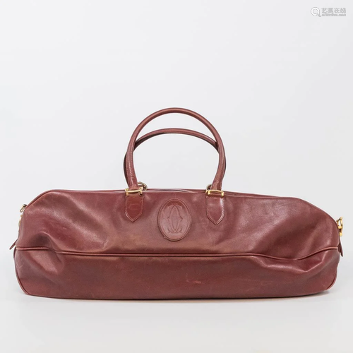 A leather Must De Cartier travel bag made of leather