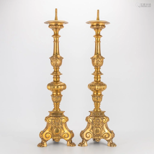 A pair of large church candlesticks made of bronze.