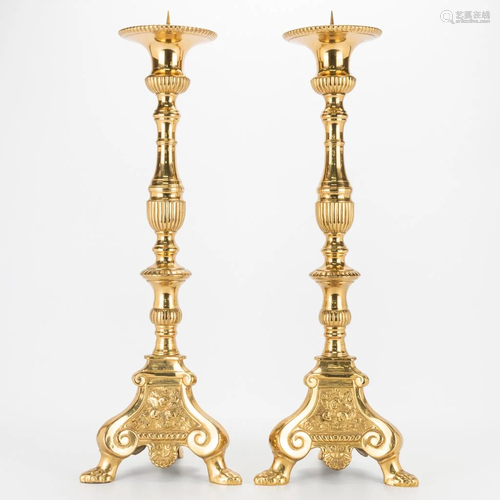 A pair of large church candlesticks made of bronze.