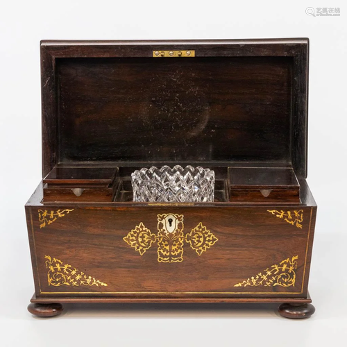 An antique tea caddy with mother of pearl marquetry