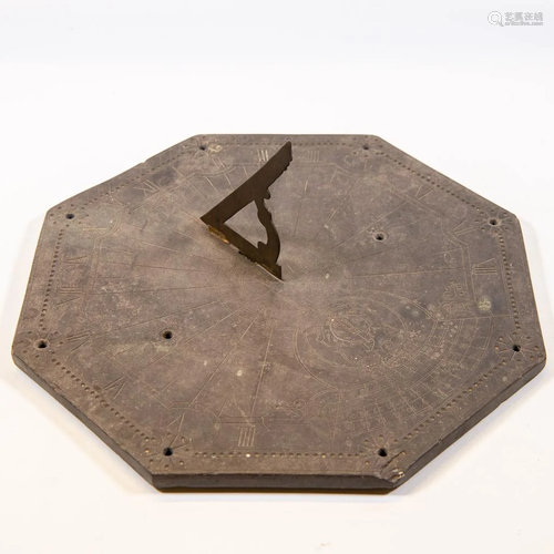 An antique sundial made of slate and marked: 'Inuirim