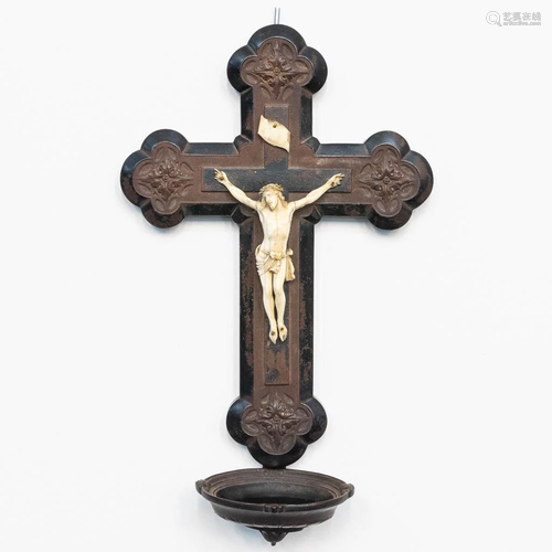 An antique crucifix with holy water font and ivory