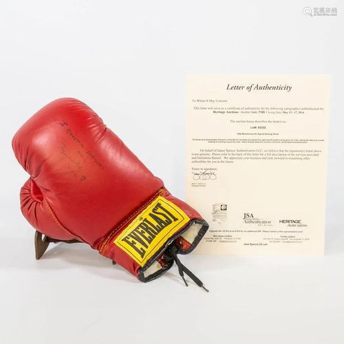 A signed boxing glove by Muhammad Ali. (12 x 32 x 19