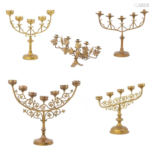 A collection of 5 church candlesticks with 5 or 7 arms.