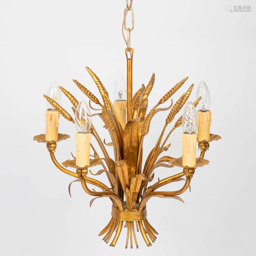 A mid-century chandelier made of brass and decorated