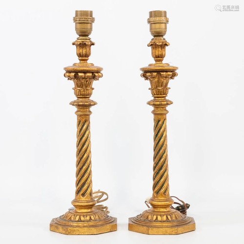 A pair of table lamps made of gilt sculptured wood. (42