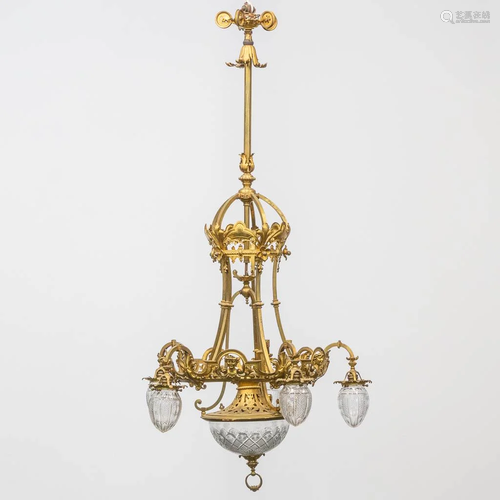 A large bronze chandelier with cut glass. Made around