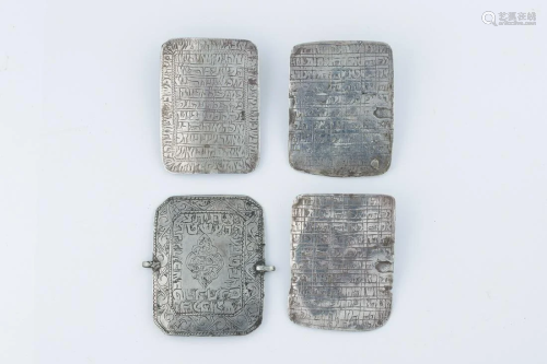 A GROUP OF FOUR SILVER SQUARE AMULETS