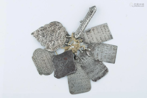 A GROUP OF EIGHT SILVER AMULETS