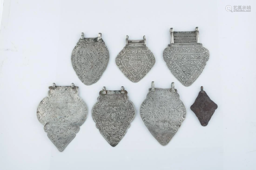 A GROUP OF SEVEN HEART SHAPED AMULETS